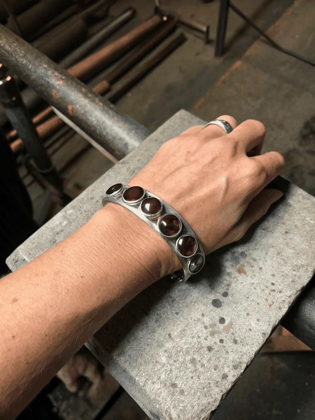 Textured metal cuff worn on wrist