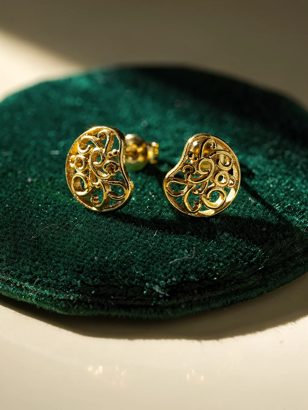 Sculpted drop earrings catching light